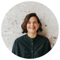 Clinical Psychologist Catherine Morey-Nase against a brick wall