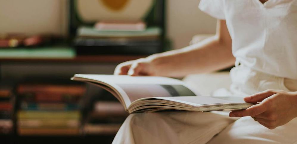 Woman with open book on her lap