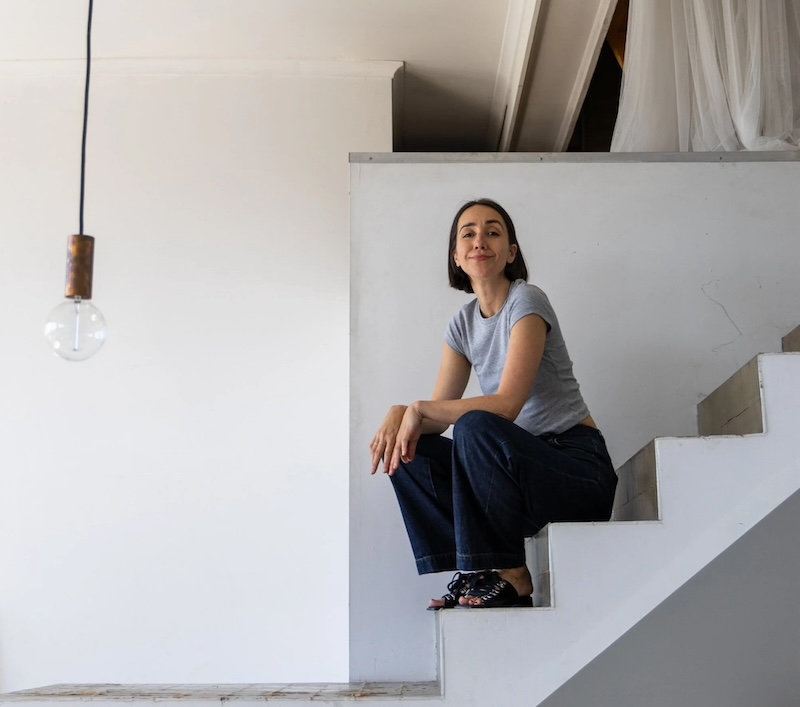Meg Callander sitting on a white staircase